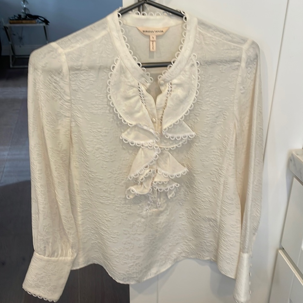 Ivory ruffle blouse.